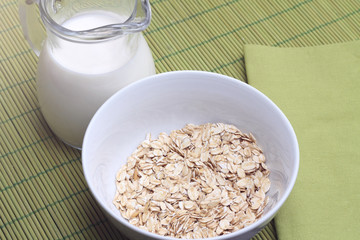 Bowl of oatmeal with milk jug