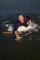 man in ice hole axe climb out