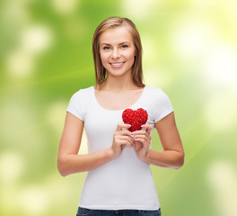 smiling woman in white t-shirt with heart