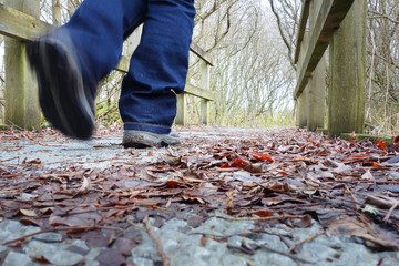 close up of a person walking over a bridge