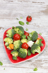 Vegetable in heart shaped plate. Diet concept. Macrobiotic.