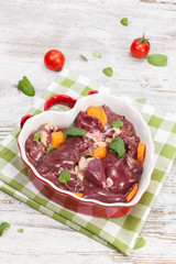 Chicken liver. Raw chicken liver in heart shaped bowl