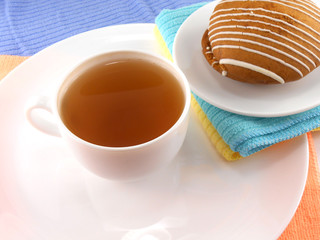 Cup of tea with cookies on plate close-up