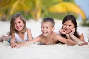 Happy children enjoy summer day at the beach