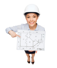 businesswoman in helmet showing with blueprint