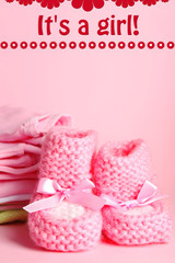 Pile of baby clothes on pink background