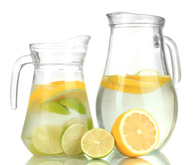 Cold water with lime, lemon and ice in pitchers isolated