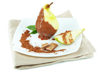 Pear in chocolate on plate isolated on white