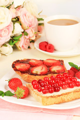 Delicious toast with berries on table close-up