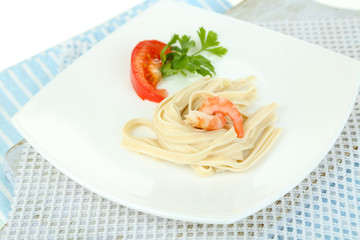 Pasta with shrimps on white plate, isolated on white