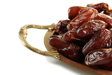 Dried dates on metal tray isolated on white