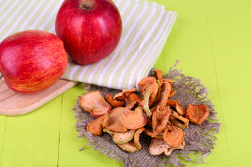 Dried apples, on cutting board,  on color wooden background