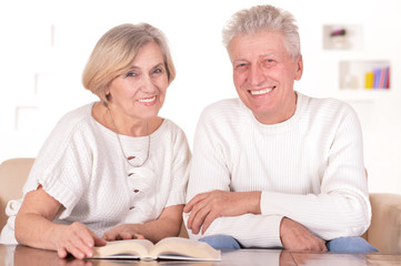 Lovely elderly couple resting at home