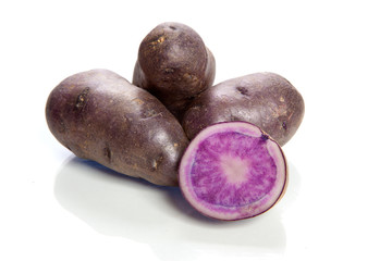 violet potatoes isolated on white background - vitelotte -