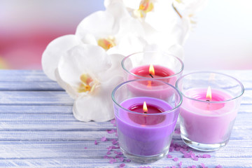Beautiful colorful candles and  orchid flowers,