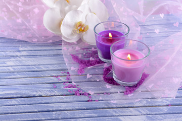 Beautiful colorful candles and  orchid flowers,