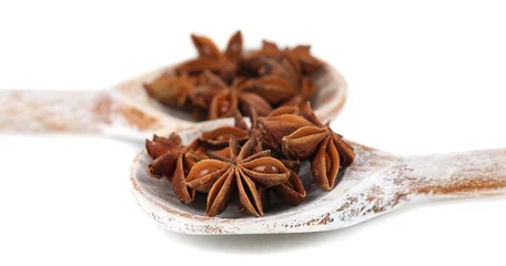 Foto op Plexiglas Star anise in wooden spoons, isolated on white © Africa Studio