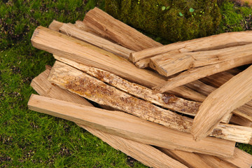 Stack of firewood on grass close up
