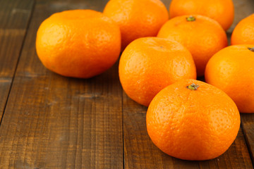 Ripe tangerines on wooden background