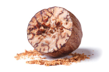 half a nutmeg and ground isolated on white background