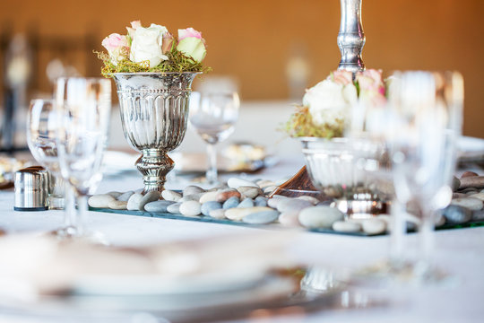 Rose bouquet in silver vase at wedding reception