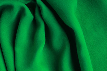 green background abstract cloth wavy folds of textile texture