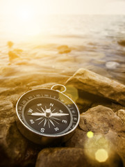 compass on the shore at sunrise - 60262537