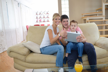 family at home using tablet computer