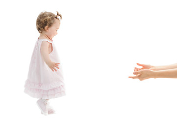 Isolated first steps of cute baby girl to her mother's arms