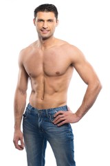 Fototapeta premium Handsome young man in blue jeans with naked torso