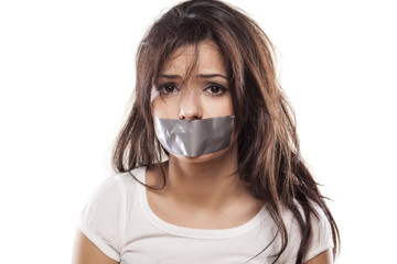 upset girl with self-adhesive tape over her mouth