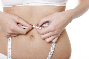 Woman measuring her waist