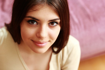 Closeup portrait of a young happy woman at home