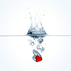Frozen movement of red heart falling into water