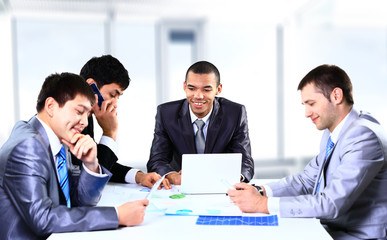 Smiling young man sitting at a business meeting