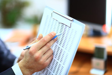Closeup of businessman's hand with document