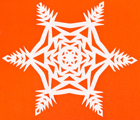 white snowflake on orange paper