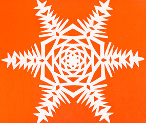 white snowflake on orange paper