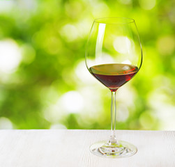 Glass of wine on nature background