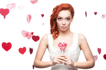 surprised red-haired woman holding lollipop
