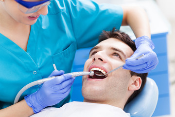 Man having teeth examined at dentists