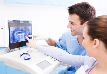 Dentist showing x-rays to patient