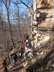 Group of people walking on a path near the cliff