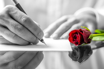 Man writing a love letter to his sweetheart