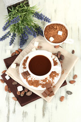 Cocoa powder in cup on napkin on wooden table