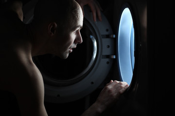 Man Looking inside the washing machine © kichigin19