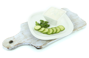 Cucumber yogurt in bowl, on white, isolated on white