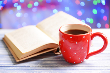 Composition of book with cup of coffee