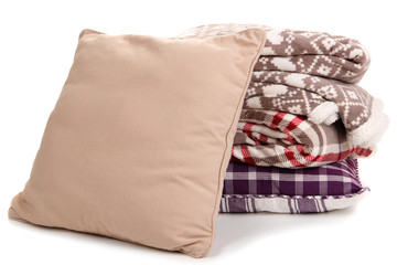 Warm plaids and pillows isolated on white