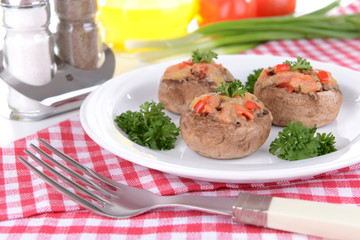 Stuffed mushrooms on plate on table close-up